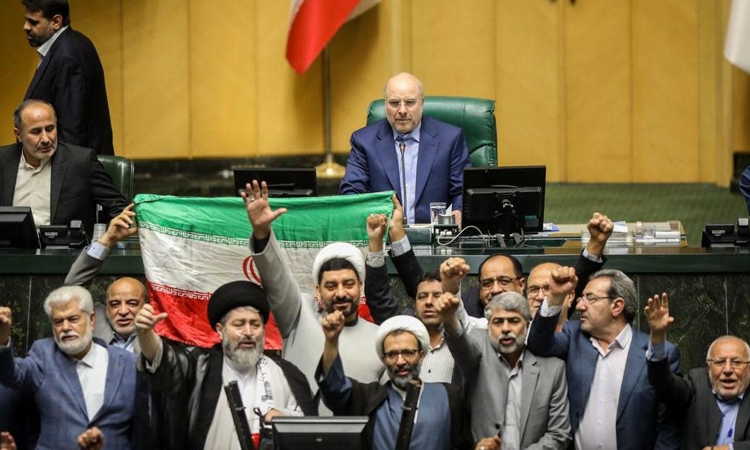 <span>Iranian lawmakers chant slogans at an open session of the parliament in Tehran on Sunday.</span><span>Photograph: Icana News Agency/Zuma Press/Rex/Shutterstock</span>