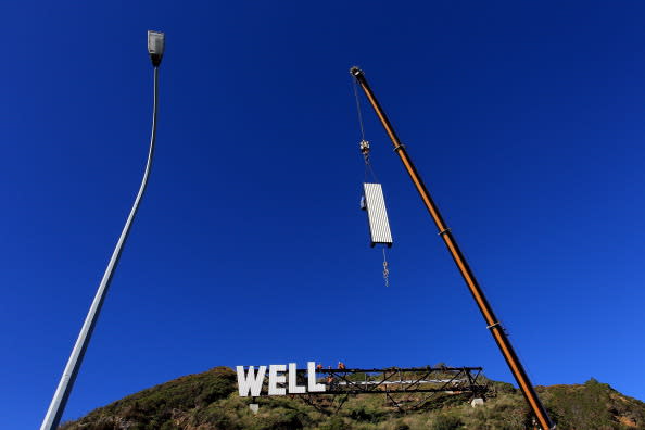 Workers install Wellington Airport's 'Wellington Blown Away' sign on July 27, 2012 in Wellington, New Zealand. The city was originally planning to put up a 'Wellywood' sign in 2010 to promote the local film industry but due to a public backlash decided to erect the sign designed by Matt Sellars and Raymond McKay. (Photo by Hagen Hopkins/Getty Images)