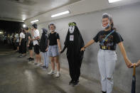 Protesters wear masks of Chinese President Xi Jinping in Hong Kong, Friday, Oct. 18, 2019. Hong Kong pro-democracy protesters are donning cartoon/superheroes masks as they formed a human chain across the semiautonomous Chinese city, in defiance of a government ban on face coverings. (AP Photo/Kin Cheung)