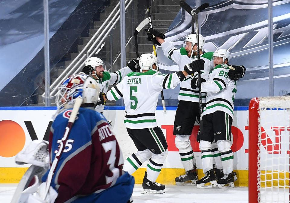 EDMONTON, ALBERTA - SEPTEMBER 04: Joel Kiviranta #25 of the Dallas Stars celebrates with Jamie Oleksiak #2, Andrej Sekera #5 and Blake Comeau #15 as goaltender Michael Hutchinson #35 of the Colorado Avalanche looks on after Kiviranta scored the game-winning goal in the first overtime period of Game Seven of the Western Conference Second Round of the 2020 NHL Stanley Cup Playoff between the Dallas Stars and the Colorado Avalanche at Rogers Place on September 04, 2020 in Edmonton, Alberta. The Stars defeated the Avalanche 5-4 in overtime to win the best of seven game series 4-3. (Photo by Andy Devlin/NHLI via Getty Images)