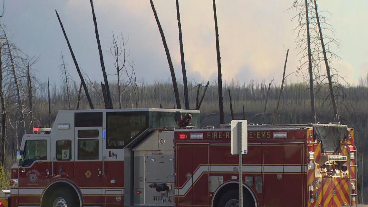 A wildfire burning in northern Alberta, about 16 kilometres southwest of Fort McMurray, has more than tripled in size since Saturday, according to Alberta Wildfire estimates. But officials are hopeful Sunday's weather will slow its growth. (Nathan Gross/CBC - image credit)