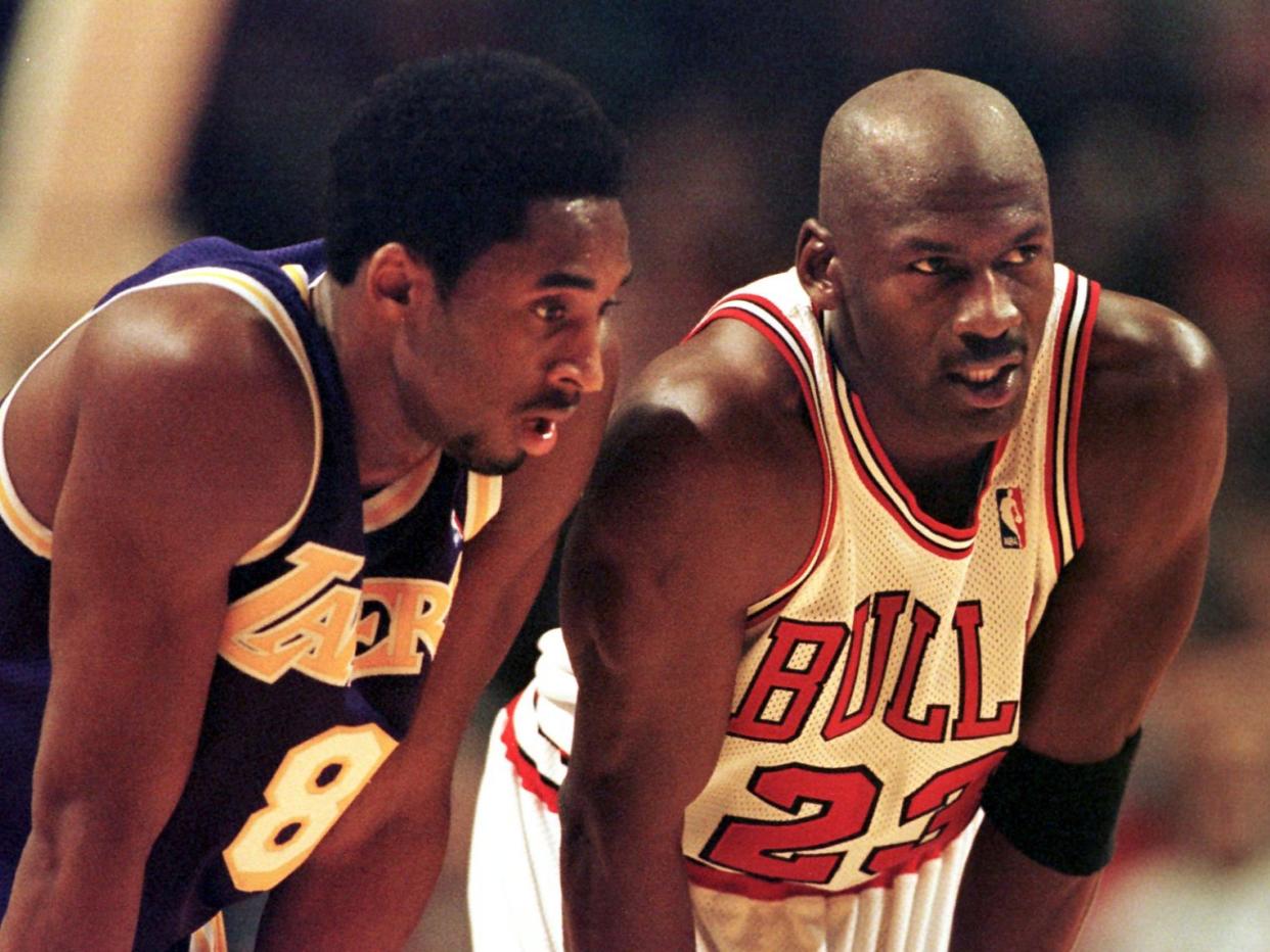 Kobe Bryant (left) on court with Michael Jordan (AFP via Getty Images)