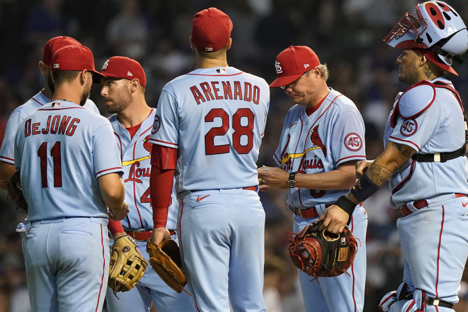 St. Louis Cardinals manager Mike Shildt, second from right, looks down while waiting for relief pitcher Junior Fernandez to arrive during the sixth inning of the team's baseball game against the Chicago Cubs in Chicago, Saturday, June 12, 2021. (AP Photo/Nam Y. Huh)