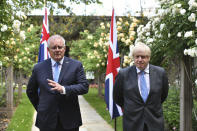 Britain's Prime Minister Boris Johnson, right, poses for a photo with Australian Prime Minister Scott Morrison after their meeting, in the garden of 10 Downing Streeet, in London, Tuesday June 15, 2021. Britain and Australia have agreed on a free trade deal that will be released later Tuesday, Australian Trade Minister Dan Tehan said. (Dominic Lipinski/Pool Photo via AP)