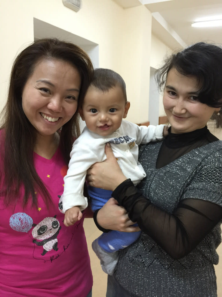 Cute as a button: The Smile Mission volunteer Florence Ng with a months-old patient she nicknamed