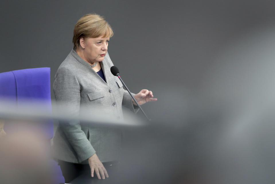 German Chancellor Angela Merkel takes questions as part of a meeting of the German parliament, Bundestag, at the Reichstag building in Berlin, Germany, Wednesday, Dec. 18, 2019. (AP Photo/Michael Sohn)