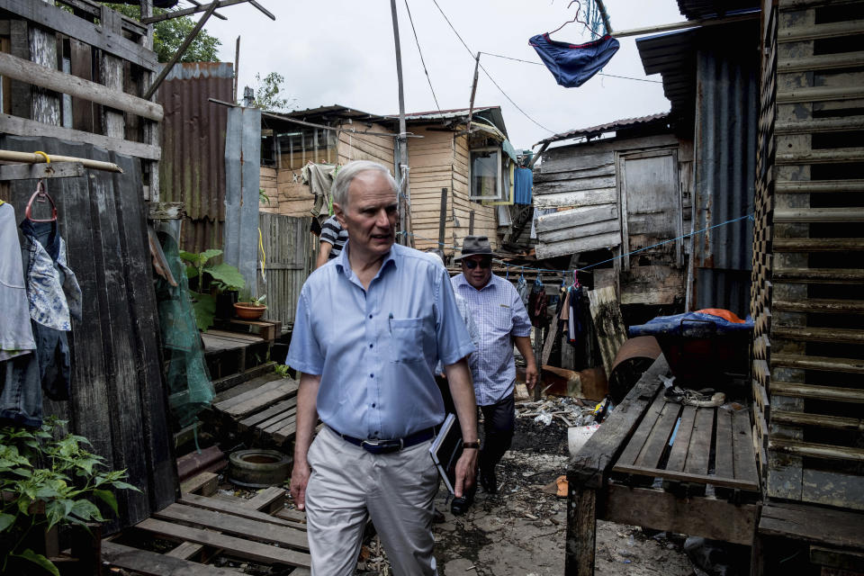 In this hand out picture taken Friday, Aug. 16, 2019, show Philip Alston, the U.N. rapporteur on extreme poverty and human rights, visiting Kampung Numbak in Sabab, east of Malaysia. Alston said Malaysia's official poverty rate, which fell from 49 percent in 1970 to just 0.4 percent in 2016, was "extremely artificial" and doesn't reflect the cost of living and excluded vulnerable populations. (Bassam Khawaja via AP)