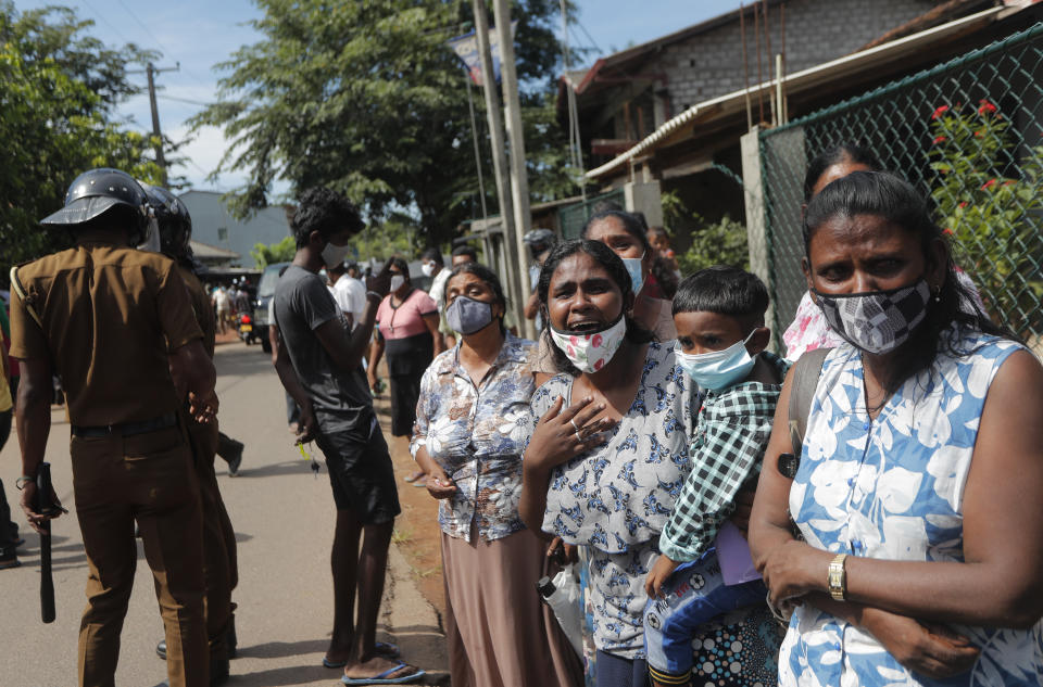 Family members of the inmates of Sri Lanka's Mahara prison complex gather demanding to know the present condition of their relatives following an overnight unrest in Mahara, on the outskirts of Colombo, Sri Lanka, Monday, Nov. 30, 2020. Sri Lankan officials say six inmates were killed and 35 others were injured when guards opened fire to control a riot at a prison on the outskirts of the capital. Two guards were critically injured. Pandemic-related unrest has been growing in Sri Lanka's overcrowded prisons. (AP Photo/Eranga Jayawardena)