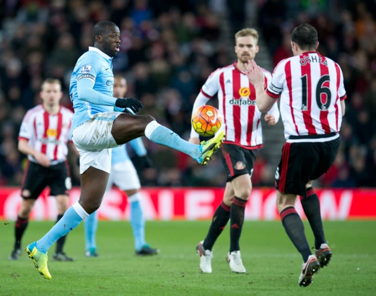 Manchester City's Yaya Toure (L) competes for the ball with Sunderland's John O'Shea during their English Premier League match, at the Stadium of Light in Sunderland, on February 2, 2016
