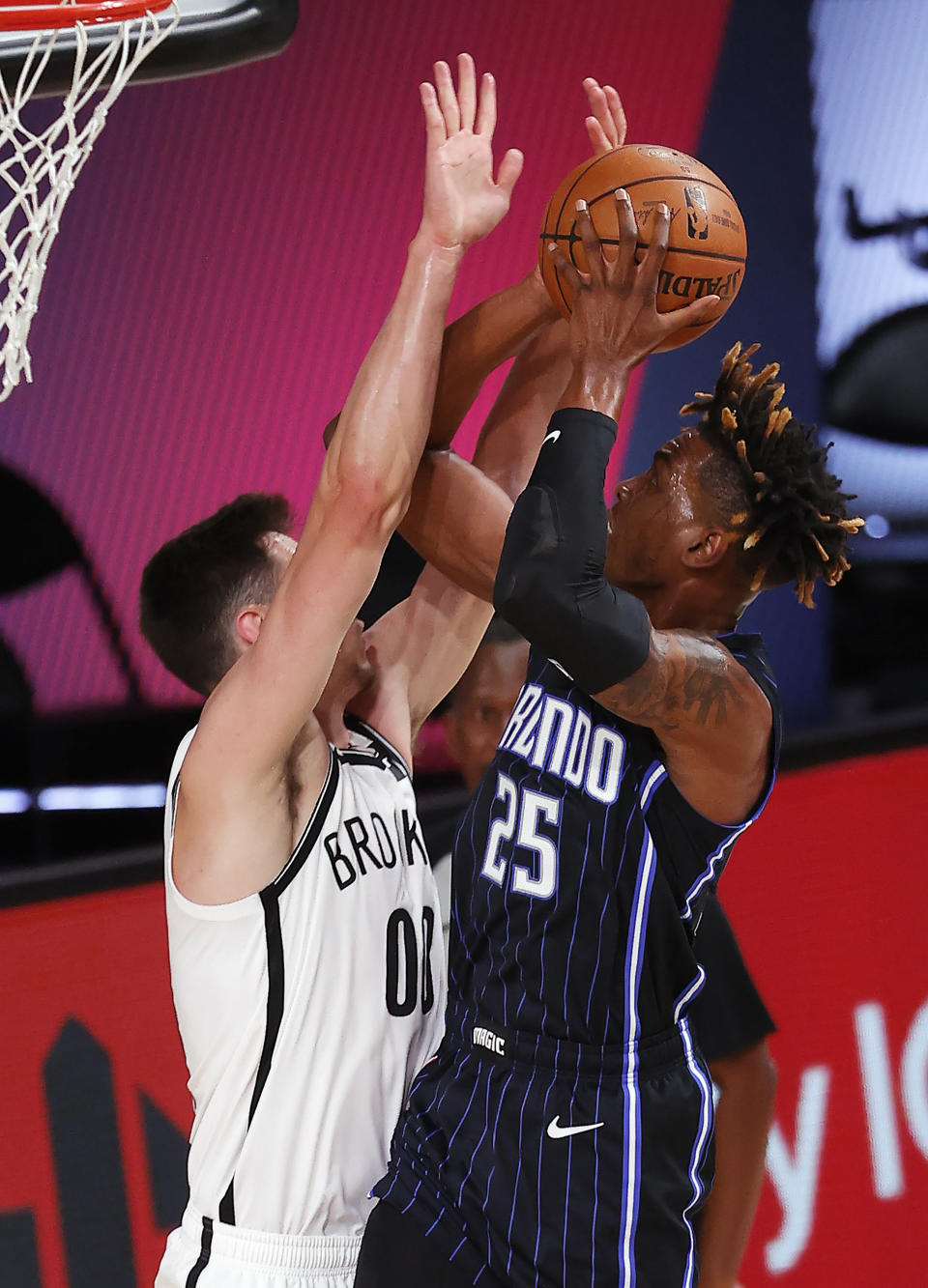 Orlando Magic's Wes Iwundu (25) goes up for a shot against Brooklyn Nets' Rodions Kurucs (00) during the first half of an NBA basketball game Tuesday, Aug. 11, 2020, in Lake Buena Vista, Fla. (Mike Ehrmann/Pool Photo via AP)