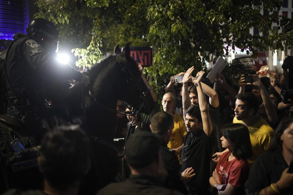 Police try to disperse demonstrators blocking a road during a protest against Israeli Prime Minister Benjamin Netanyahu's government, and calling for the release of hostages held in the Gaza Strip by the Hamas militant group, in Tel Aviv, Israel, Saturday, May 18, 2024. (AP Photo/Leo Correa)