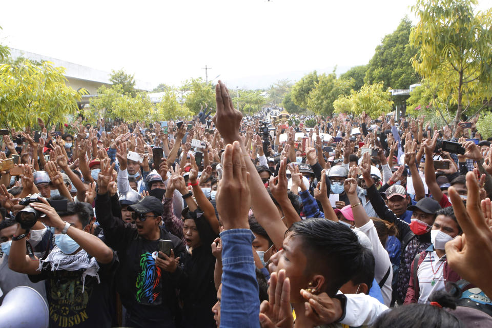 Supporters give the three-finger salute during Mya Thwate Thwate Khaing's funeral, in Naypyitaw Myanmar, Sunday, Feb. 21, 2021. Mya Thwet Thwet Khine was the first confirmed death among the many thousands who have taken to the streets to protest the Feb. 1 coup that toppled the elected government of Aung San Suu Kyi. (AP Photo)