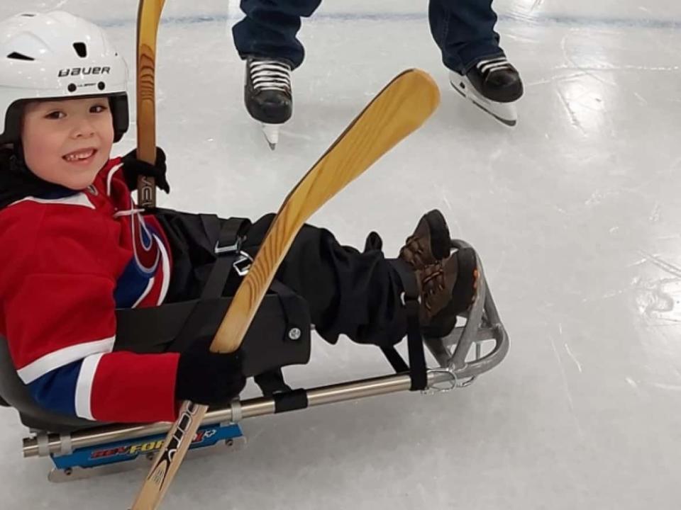 Six-year-old Owen Raymond has spina bifida. His mother Victoria Stack says there isn't too much for him to do in the town of Labrador City, so she was happy to see sledge hockey brought in as an option.  (Submitted by Victoria Stack - image credit)