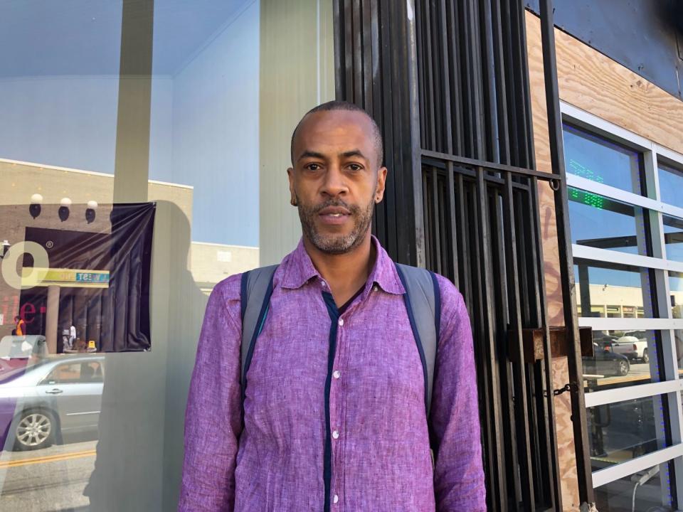 Derrick Dillard stands outside a storefront in Atlanta.