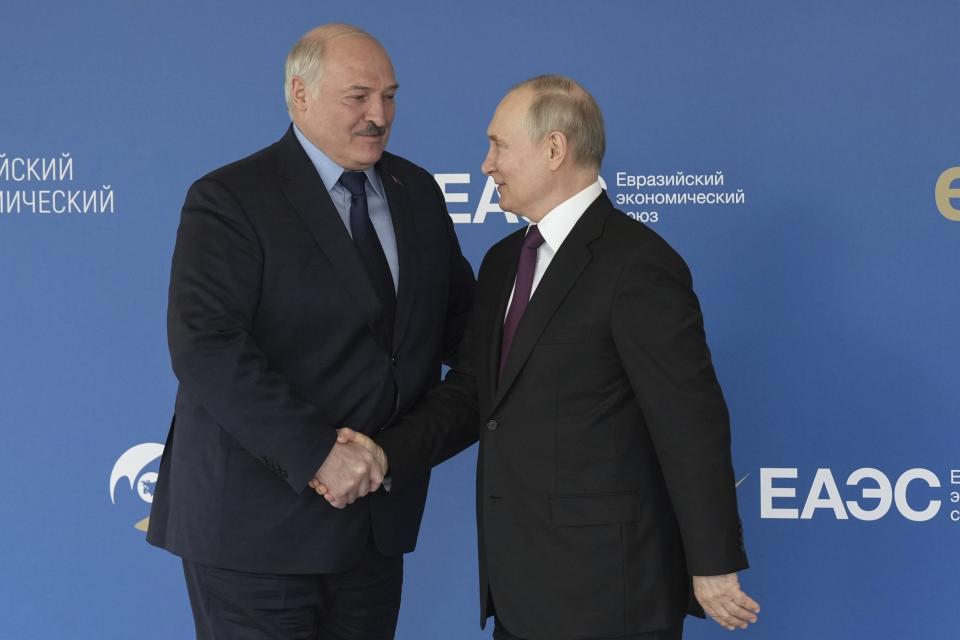 In this photo released by Roscongress Foundation, Russian President Vladimir Putin, right, and Belarusian President Alexander Lukashenko greet each other prior to the plenary session of the Eurasian Economic Forum in Moscow, Russia, Wednesday, May 24, 2023. (Sergey Shinov, Roscongress Foundation via AP)