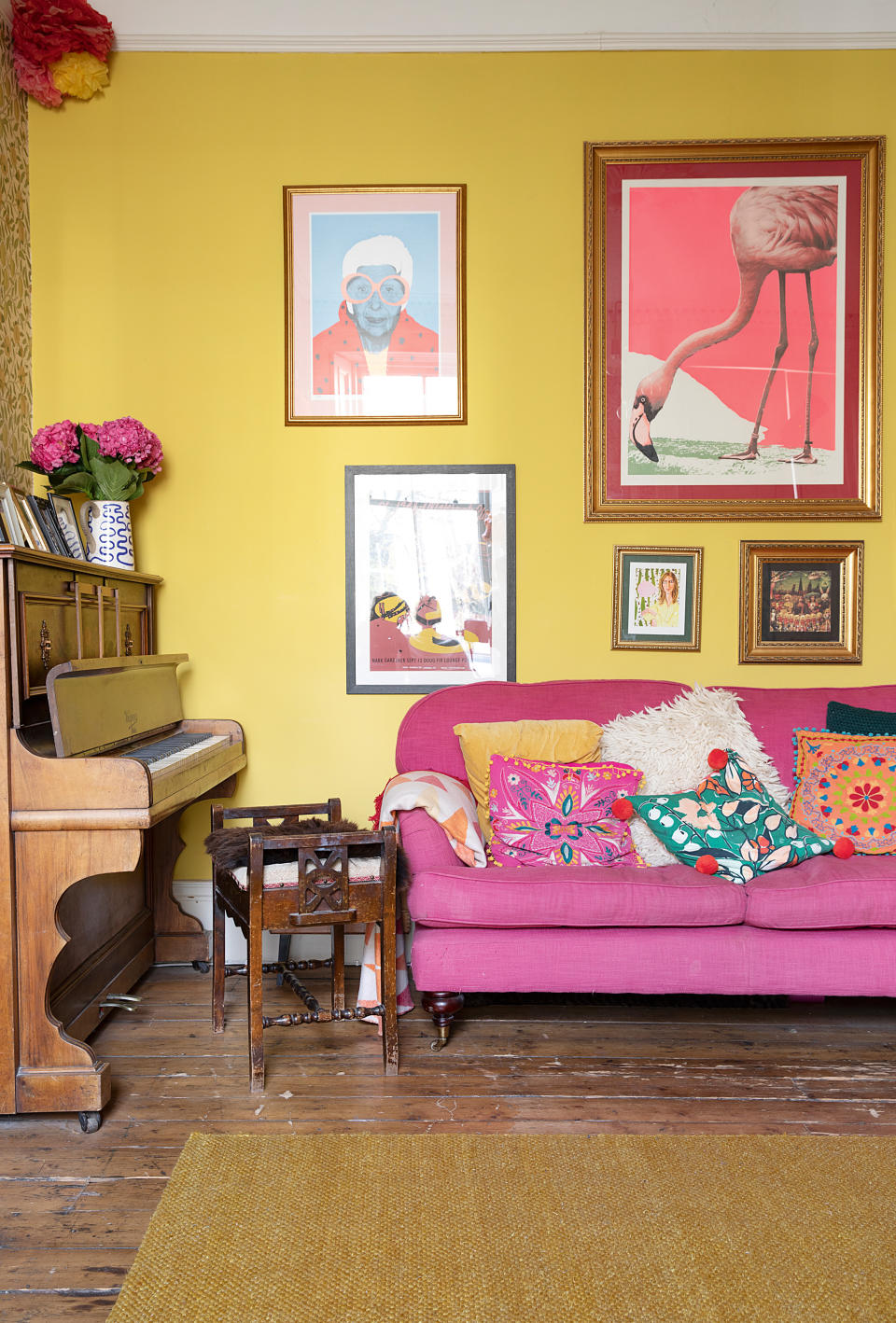 <p> You just can&apos;t look at this room without feeling happier, right?&#xA0; </p> <p> Pink and yellow are a bold combo yes, but styled right together they can look really chic, in a fun and creative way. This living room actually feels really classic and elegant, despite the bold colors. </p> <p> The wooden accents and quirky gallery wall idea complete the look perfectly &#x2013; they are eccentric but also liveable, and we love it. </p>