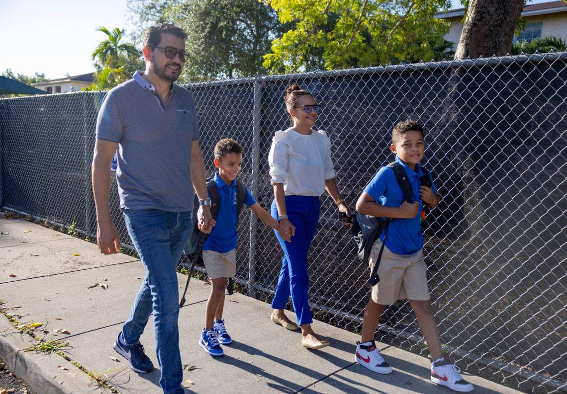 From left: Julio, Matteo, Sophia, and Luka Santa walk into the first day of school at Sunset Elementary School on Wednesday, Aug. 17, 2022, in Miami. The Santa family recently moved to Miami from Haiti where Julio was the former consulate for Colombia.