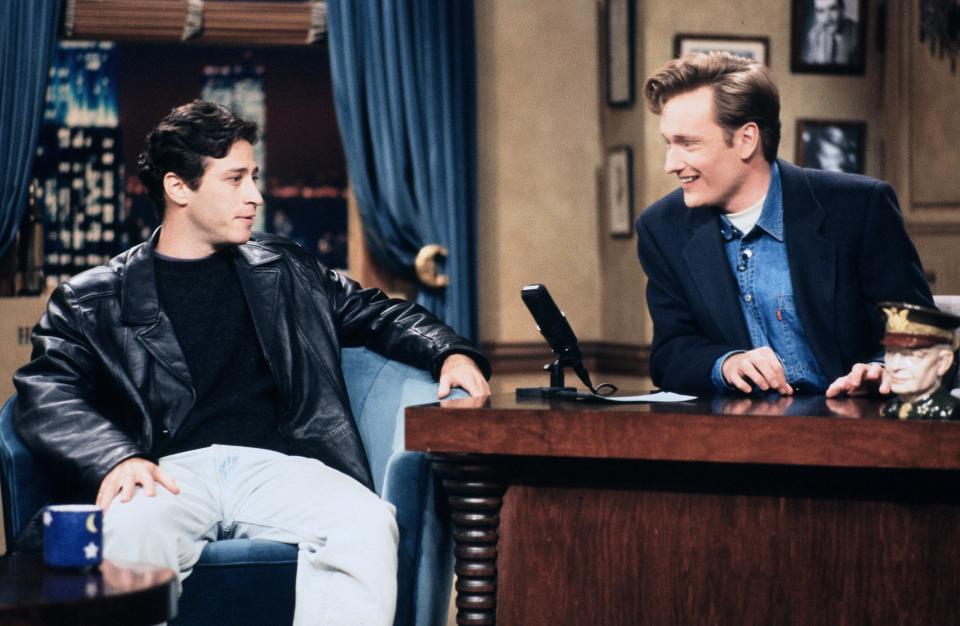 Young Jon Stewart appears on Conan's show in the early '90s (hence the regrettable denim).