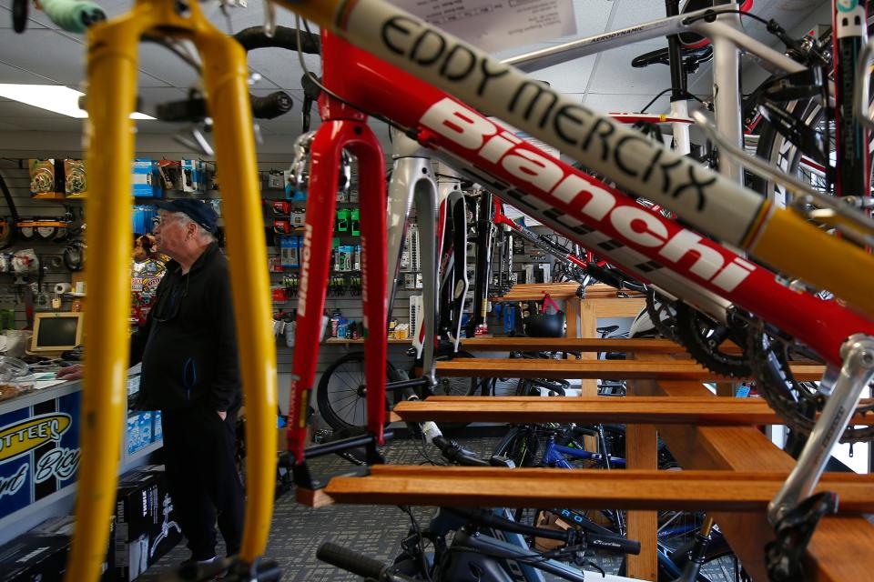 A customer takes a look at some of the accessories for sale at Scottee's Westport Bicycle on Route 6 in Westport, after dropping off his bicycle for a tune-up.