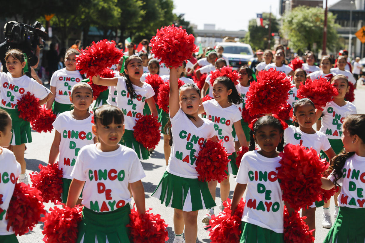 FILE -Cheerleaders from Brookline Elementary march during the LULAC Cinco De Mayo parade Saturday, May 3, 2014 in downtown Houston. American bars and restaurants gear up every year for Cinco de Mayo, offering special deals on Mexican food and alcoholic drinks for the May 5 holiday that is barely celebrated south of the border. (Eric Kayne/Houston Chronicle via AP, File)