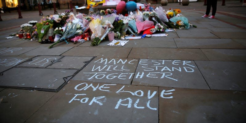 A woman looks at flowers for the victims of the Manchester Arena attack, in central Manchester Britain. REUTERS/Stefan Wermuth