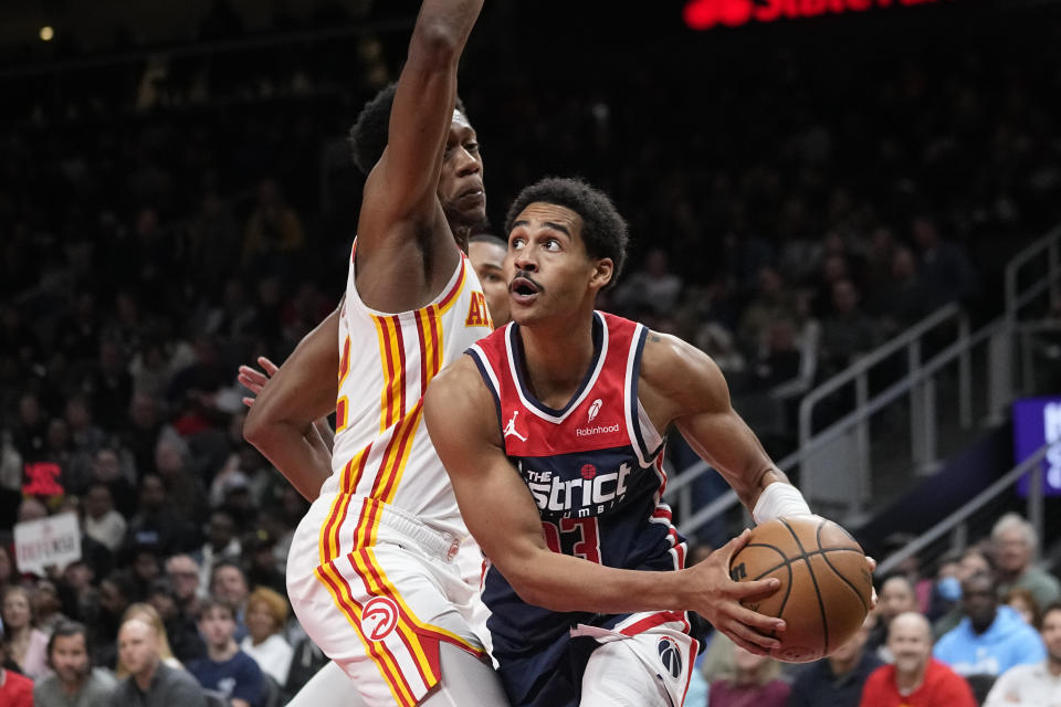 Washington Wizards guard Jordan Poole (13) works against Atlanta Hawks forward De'Andre Hunter (12) during the first half of an NBA basketball game, Wednesday, Nov. 1, 2023, in Atlanta. (AP Photo/John Bazemore)