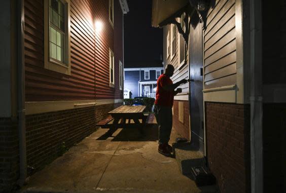 Lincoln conducts security checks during his overnight house manager shift at Amos House