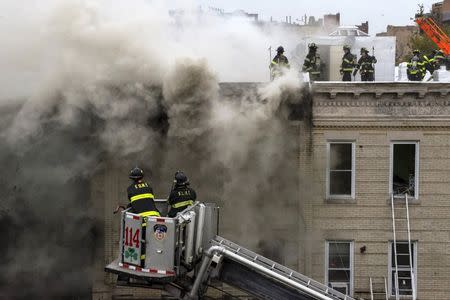 Firefighters respond to an apparent gas explosion and fire in the Brooklyn borough of New York, October 3, 2015. REUTERS/Stephanie Keith