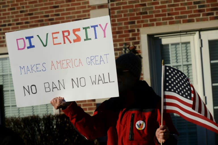 A man protests outside of Republican Rep. Mike Bishop's office on February 13, 2017 in Brighton, Michigan