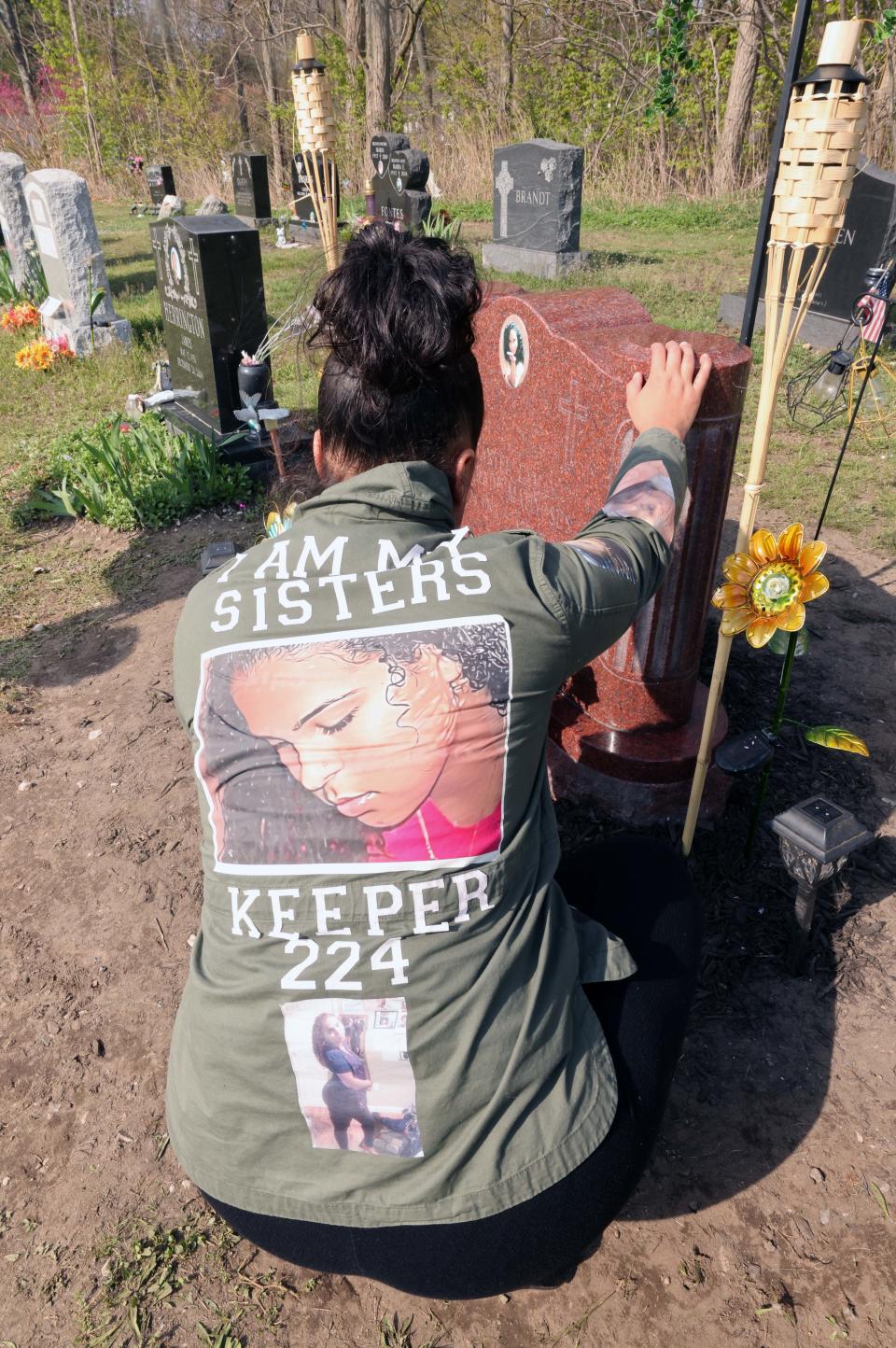 Tiffany Andrade, sister of the late Chantel Matiyosus, is at her sister's gravesite at the Calvary Cemetery in Brockton on Wednesday, April 26, 2023, a day after the grave was vandalized with pink paint on the 14th anniversary of her sister's murder.