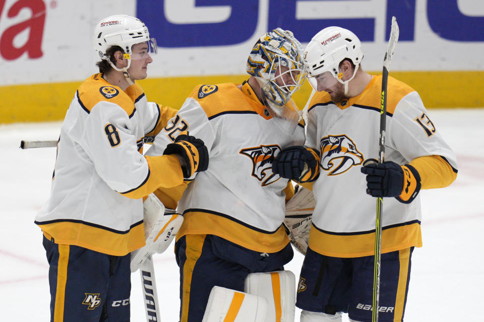 Nashville Predators center Cody Glass (8), goaltender Kevin Lankinen (32) and center Yakov Trenin (13) celebrate the team's 3-2 win over the Washington Capitals in an NHL hockey game Friday, Jan. 6, 2023, in Washington. (AP Photo/Jess Rapfogel)