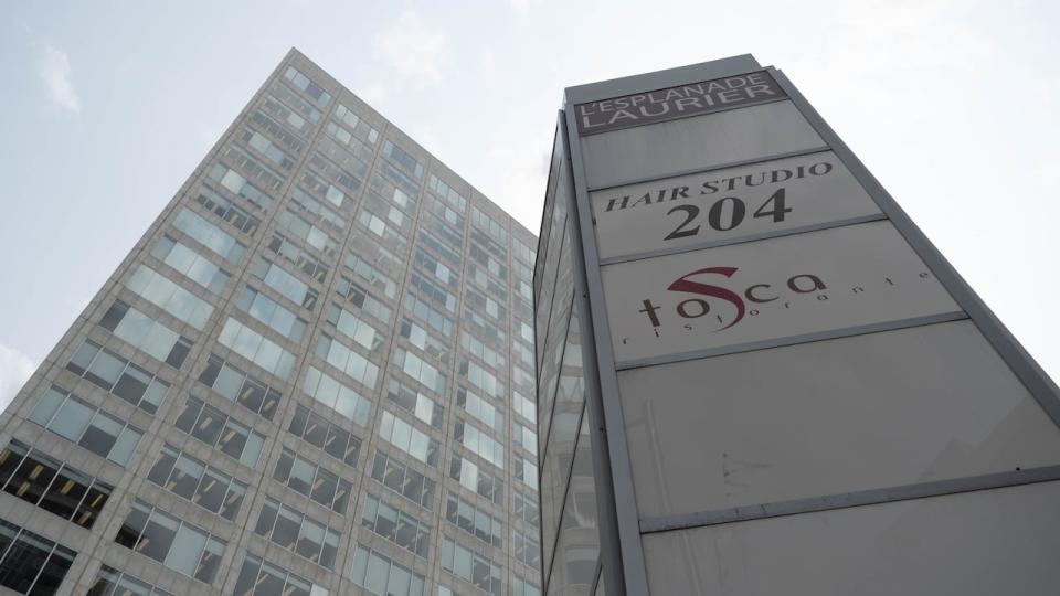 The sign outside the L'Esplanade Laurier office complex in downtown Ottawa on May 19, 2023. It is one of 10 properties in the national capital region on a PSPC disposal list. (Jean Delisle/CBC News - image credit)