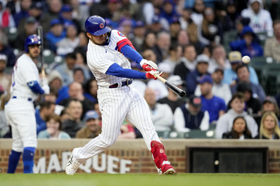 Chicago Cubs' Seiya Suzuki hits an RBI double off New York Mets starting pitcher Kodai Senga during the third inning of a baseball game Wednesday, May 24, 2023, in Chicago. (AP Photo/Charles Rex Arbogast)