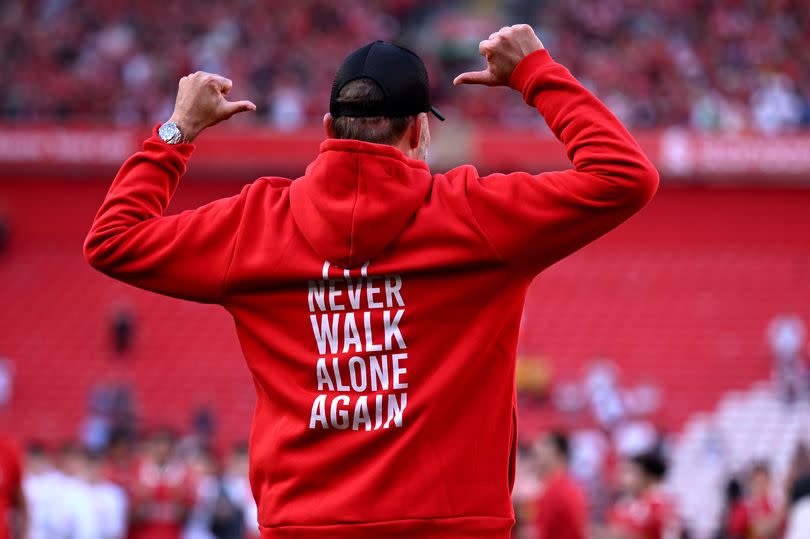 Liverpool manager Jurgen Klopp salutes the Kop after his final game in charge against Wolverhampton Wanderers at Anfield on May 19, 2024