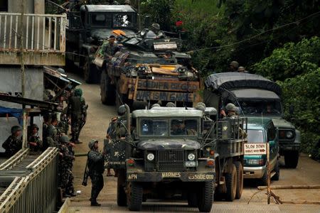 Philippines army soldiers return from an operation to retrieve bodies of casualties from the fighting zone in Marawi City, Philippines June 28, 2017. REUTERS/Jorge Silva