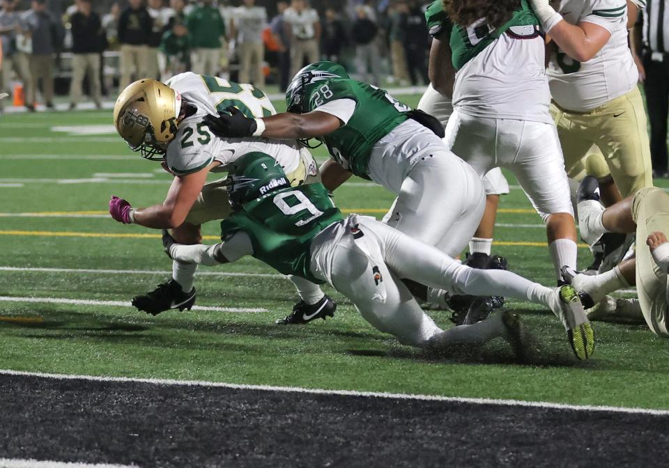 St. Bonaventure's Koen Glover scores a touchdown despite the effort of Pacifica's Taylor Lee and Jorge Villegas during the third quarter of the teams' nonleague showdown at Pacifica High on Friday, Aug. 25, 2023. Pacifica won 24-13.