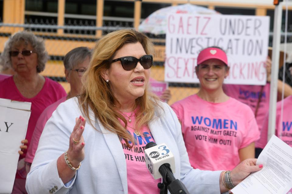 Samantha Herring, founder of Women Against Matt Gaetz, speaks to reporters Tuesday outside of the Okaloosa County School Board Administration building in Niceville. About two dozen members of the group gathered to oppose Gaetz's meeting with students at Niceville High School.