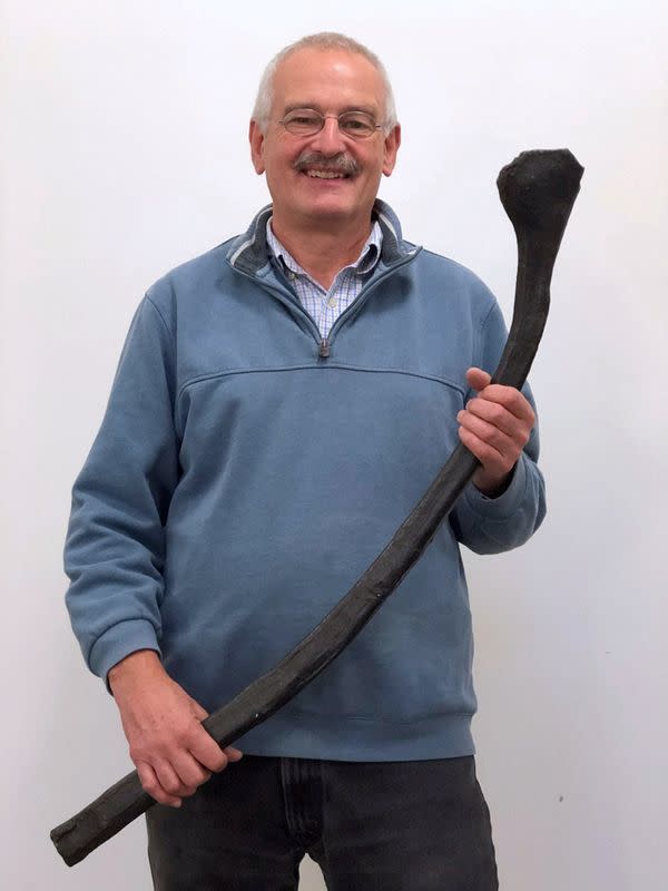 University of Bonn palaeontologist Martin Sander holds a fossilized rib of a prehistoric marine reptile