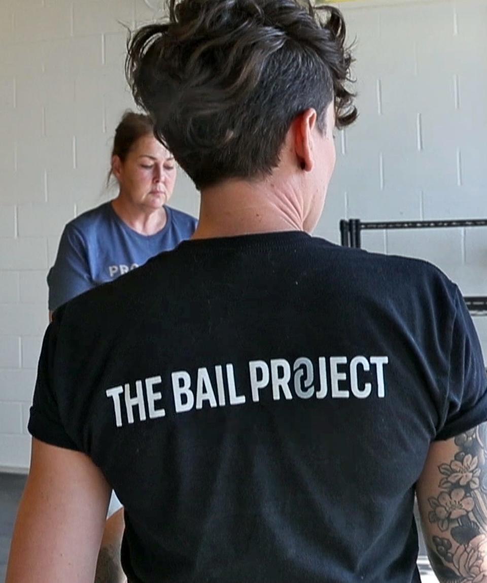 April Angermeier, right, gets ready to take a photo of Kathleen Merchant, Thursday, Sept. 19, 2019.  Angermeier is with The Bail Project.  The national nonprofit is now in Indianapolis.  It pays the bail for low-level offenders who otherwise wouldn't be able to afford bail and would have to await trial in jail.  Merchant was one of the people helped by The Bail Project.  They paid her $500 bail to get her released in June, 2019.  Her case has since been dismissed.