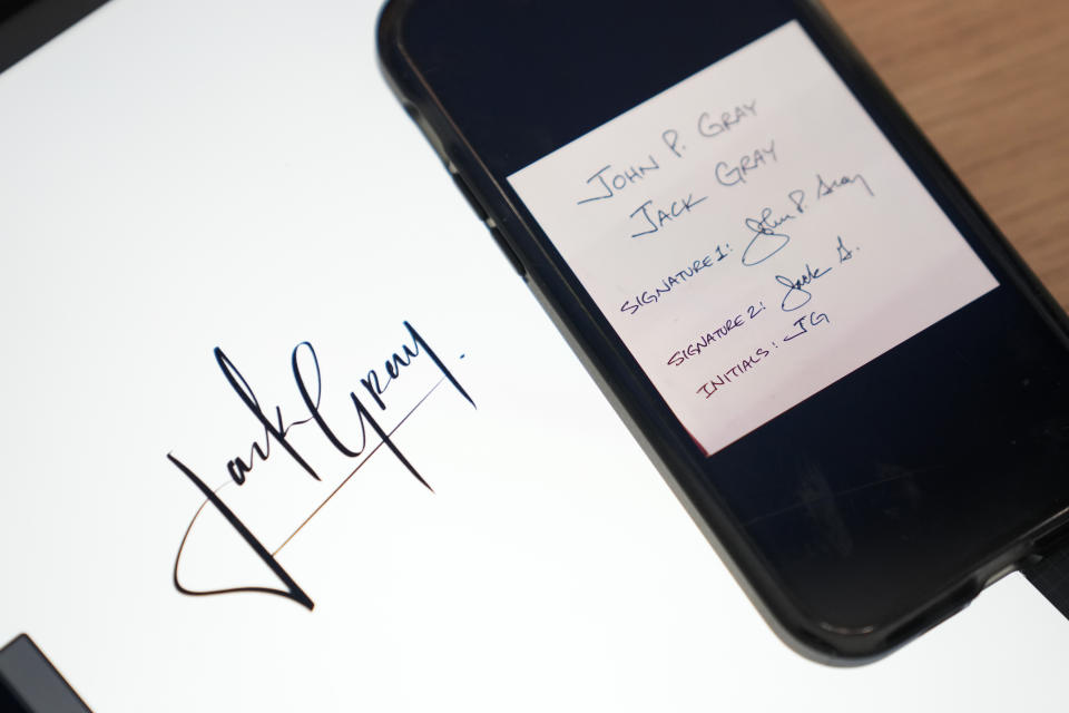 A custom signature created by Priscilla Molina, left, appears next to images of original client signatures and initials on a cell phone in Los Angeles on Feb. 22, 2023. Molina designs a minimum of 300 custom signatures a month, offering packages that include up to three ways to sign, limitless drafts or a new set of initials. (AP Photo/Ashley Landis)