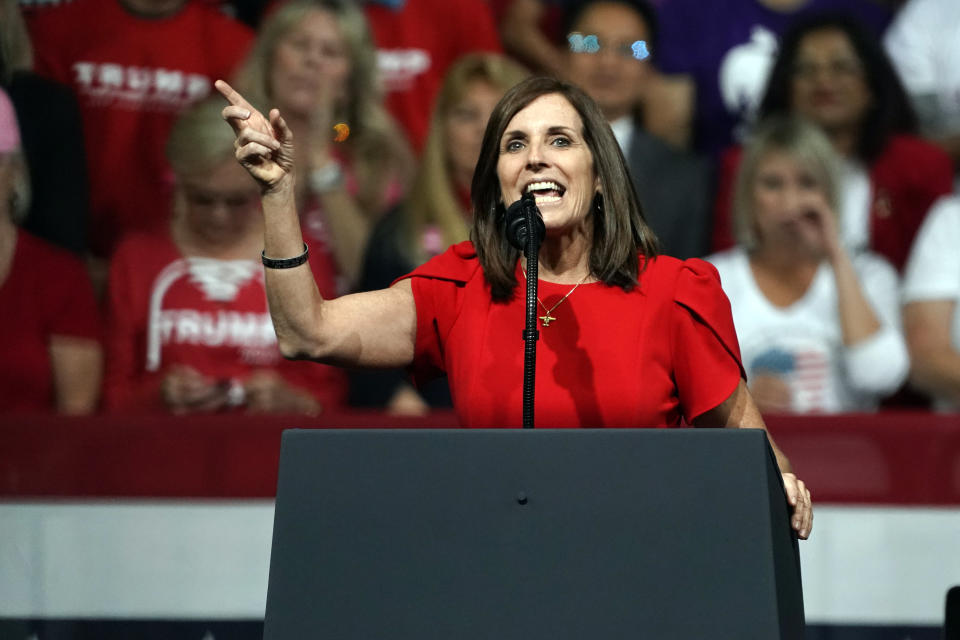 FILE - In this Feb. 19, 2020, file photo, Sen. Martha McSally, R-Ariz., speaks at a rally for President Donald Trump in Phoenix. McSally is volunteering at the Salvation Army. Mark Kelly is using his background as an astronaut to entertain kids stuck at home. The global pandemic that is shaking up life is also forcing Arizona's U.S. Senate candidates to reinvent the political playbook when voters are much more concerned about staying healthy and paying the bills than they are with politics. (AP Photo/Rick Scuteri, File)