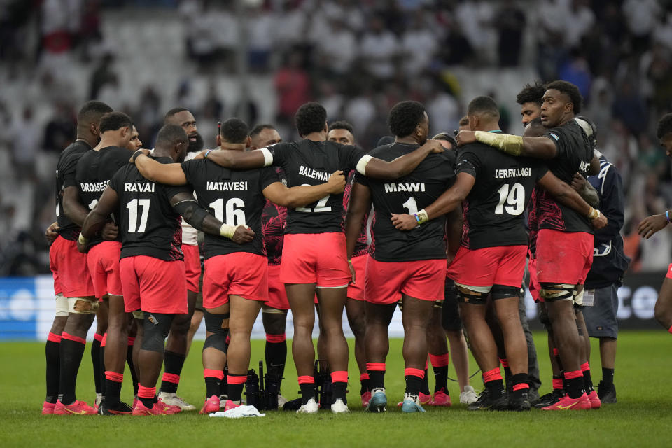 Fiji's players hug at the end of the Rugby World Cup quarterfinal match between England and Fiji at the Stade de Marseille in Marseille, France, Sunday, Oct. 15, 2023. (AP Photo/Pavel Golovkin)