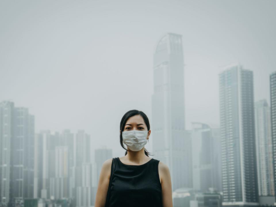 Woman smog skyline pollution mask