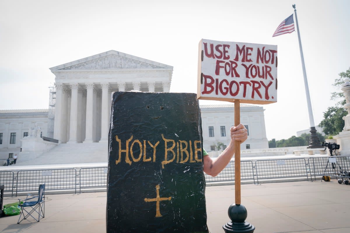 A person protests outside the Supreme Court (AP)