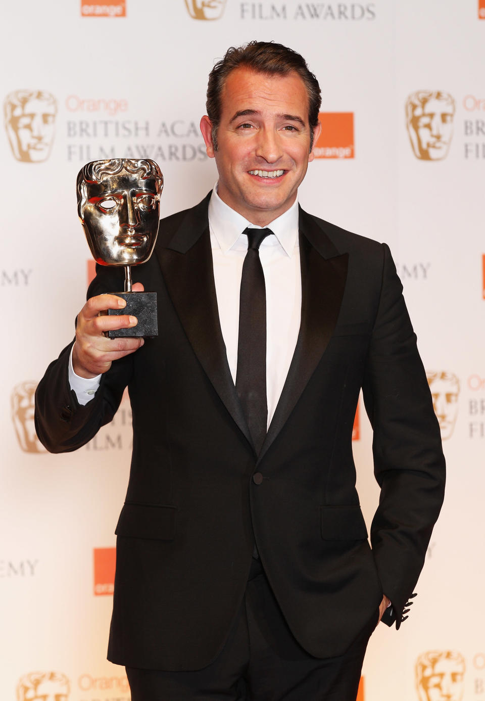 LONDON, ENGLAND - FEBRUARY 12: Jean Dujardin poses in the press room with the Best Actor award during the Orange British Academy Film Awards 2012 at the Royal Opera House on February 12, 2012 in London, England. (Photo by Chris Jackson/Getty Images)