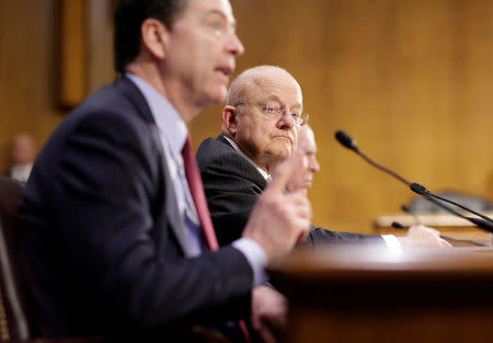 Director of National Intelligence (DNI) James Clapper listens as FBI Director James Comey testifies to the Senate Select Committee on Intelligence hearing on “Russia’s intelligence activities" on Capitol Hill in Washington, U.S. January 10, 2017. REUTERS/Joshua Roberts