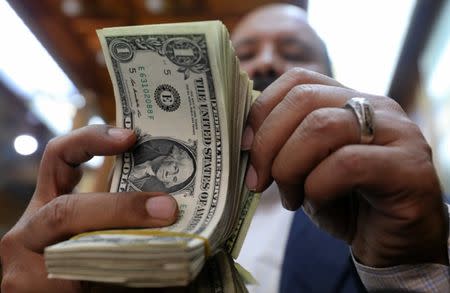 A man counts U.S dollars at a money exchange office in central Cairo, Egypt, March 7, 2017. REUTERS/Mohamed Abd El Ghany