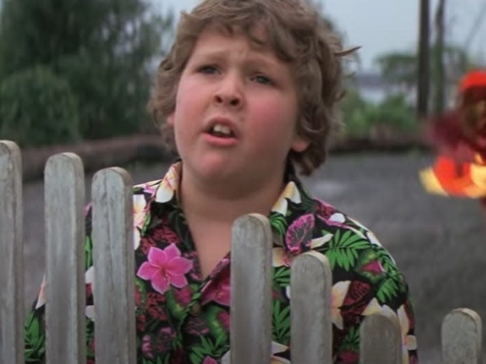 Jeff Cohen as Chunk in "The Goonies" looking over a fence