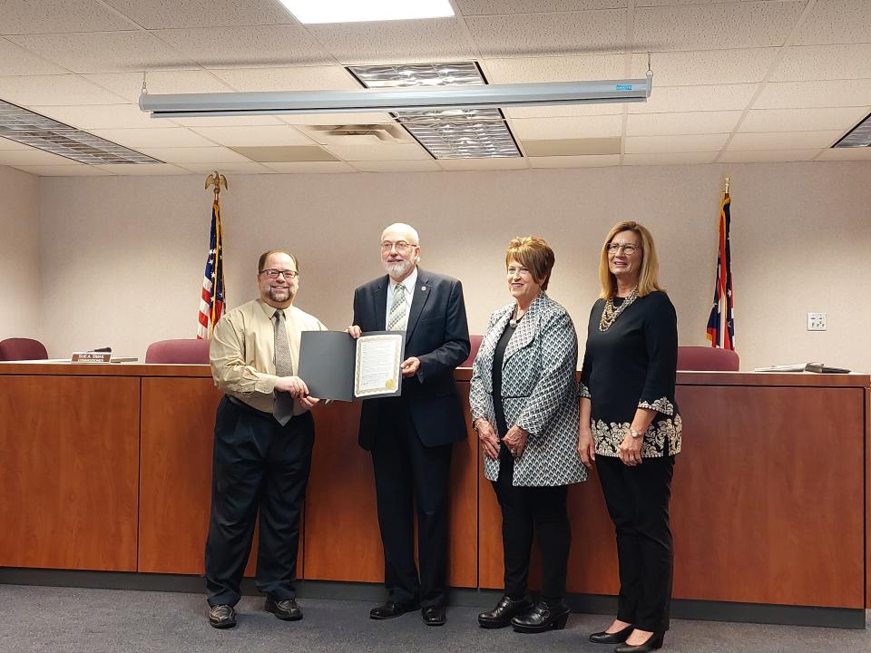 Wayne County Health Commissioner Nicholas Cascarelli (left to right) accepts a proclamation Wednesday from Commissioners Ron Amstutz, Becky Foster and Sue Smail.