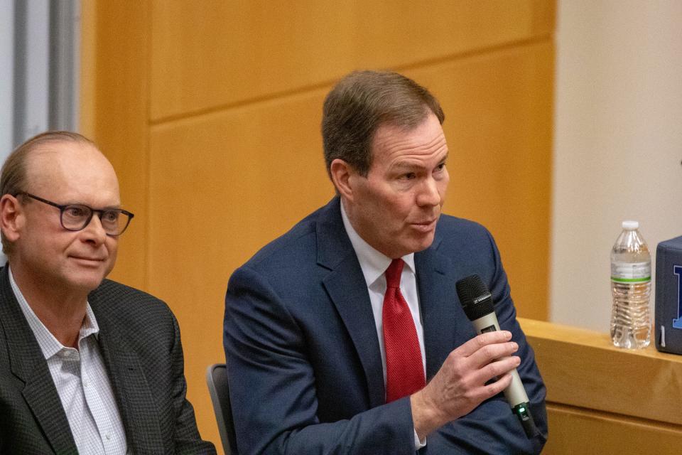 Washington Trust CFO Ronald Ohsberg talks during an April 1 panel discussion at the University of Rhode Island while Amica Mutual Insurance CFO James Loring Jr. listens.